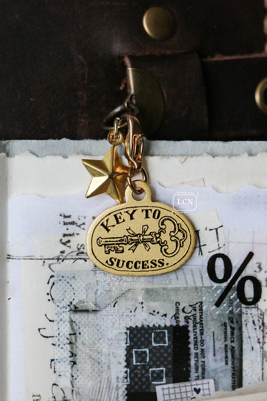 LCN Brass Charm: Key to Success